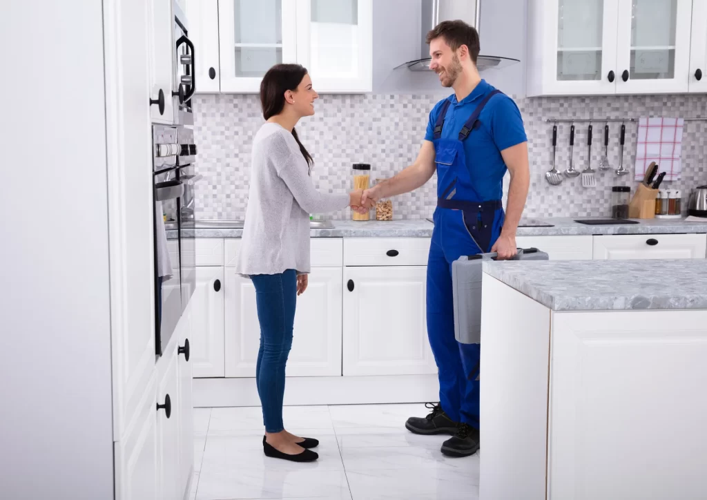 Plumber shaking hands with a homeowner after discussing hidden plumbing costs in Springdale, AR