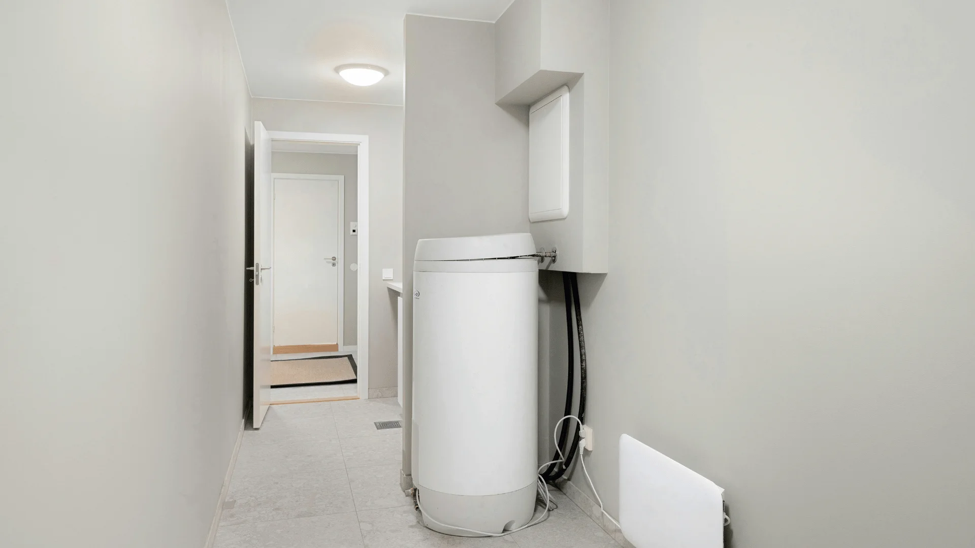 Hot Water Tank and Electric Heater in the Laundry Room